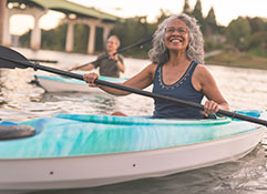 Photo of a woman kayaking. Link to Life Stage Gift Planner Ages 60-70 Gifts.